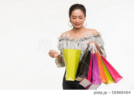 Asian woman carry colorful paper bags.. Asian woman carry colorful paper bags.. 56966404