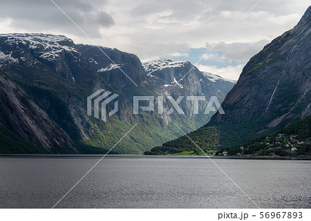Landscape of Hardangerfjord with cloudy sky in early summer season, Norway.	 56967893