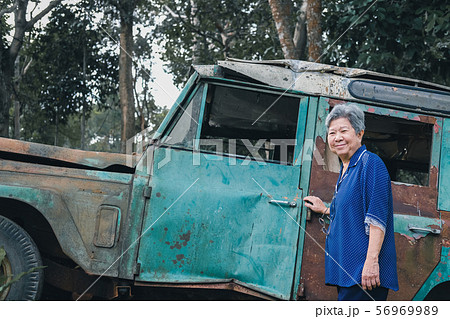 senior woman with old jeep car 56969989