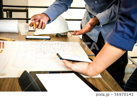 architect interior designer working with house drawing plan & color swatch architect interior designer working with house drawing plan & color swatch 56970141