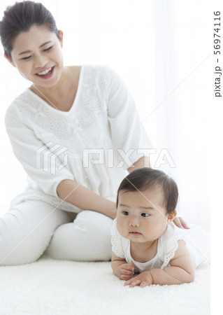 寝転ぶ赤ちゃんと母親 寝転ぶ赤ちゃんと母親 56974116