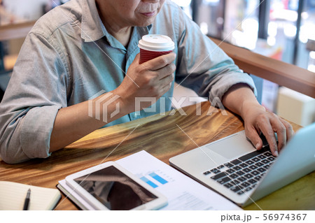 Businessman in casual style working with graph Businessman in casual style working with graph 56974367