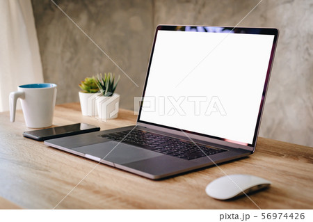 Laptop computer with blank screen on table. 56974426