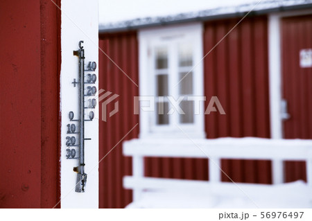 outdoor thermometer on a wooden house 56976497