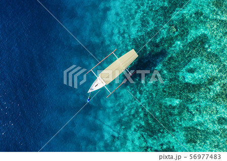 Boat on the water surface from top view. Boat on the water surface from top view. 56977483