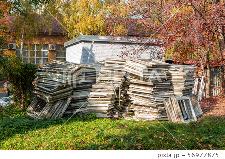 Heap of old wooden window frames with glass 56977875