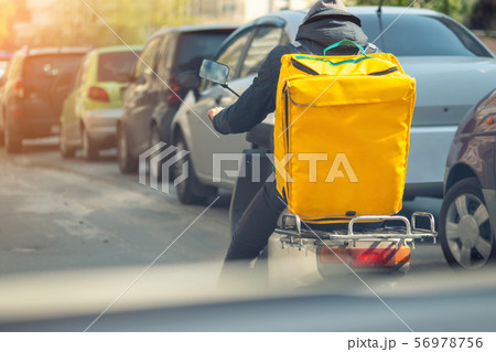 Food delivery courier with big yellow backpack Food delivery courier with big yellow backpack 56978756