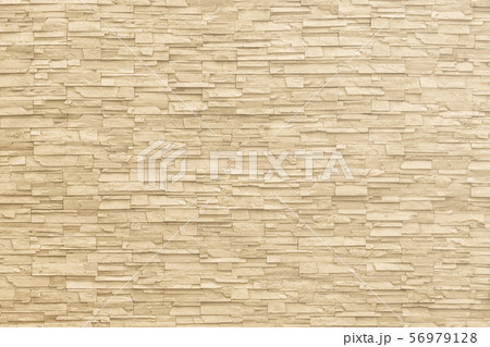 Rock stone brick tile wall aged texture detailed pattern background in yellow cream beige color 56979128