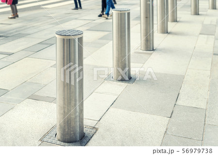 Stainless steel bollard entering pedestrian area 56979738