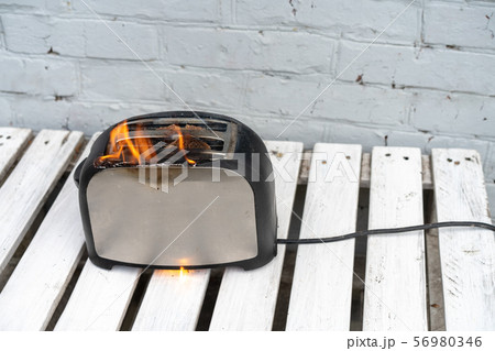 Burning toaster. Toaster with two slices of toast Burning toaster. Toaster with two slices of toast 56980346