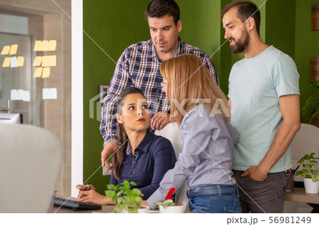 Young female manager having a conversation with her team in the office 56981249