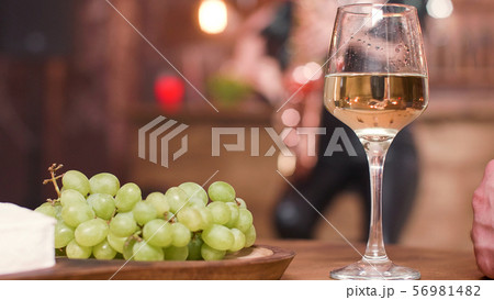 Close up pf wine glass on the table of a jazz club Close up pf wine glass on the table of a jazz club 56981482