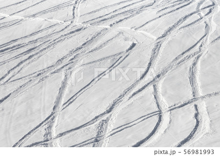 Snowy off-piste ski slope with trace from skis and Snowy off-piste ski slope with trace from skis and 56981993