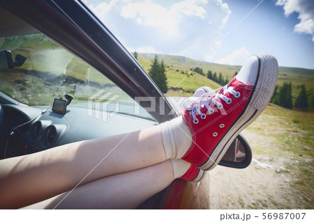 Girl legs sticking out of the car Girl legs sticking out of the car 56987007