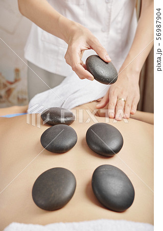 Woman receving hot stone massage 56987904