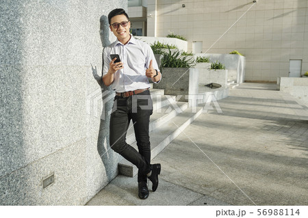 Positive buisnessman at his office building 56988114