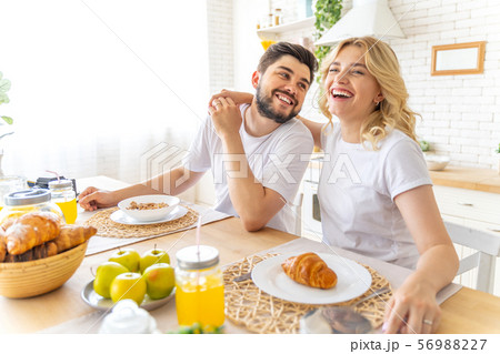 Happy couple is having breakfast at home Happy couple is having breakfast at home 56988227