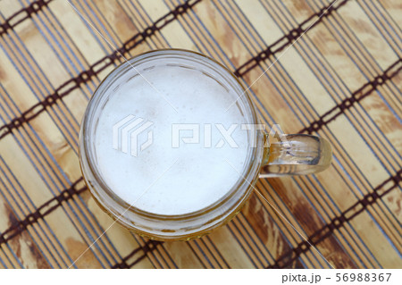 Glass mug of unfiltered weizen beer on table 56988367
