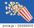 popcorn in classic red box splashing of the box , blue background with clipping path 56988909