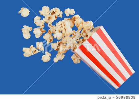 popcorn in classic red box splashing of the box , blue background with clipping path 56988909