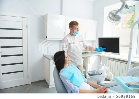 Smiling lady listening carefully to the doctor Smiling lady listening carefully to the doctor 56989168