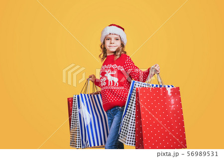 Cute girl with Christmas presents Cute girl with Christmas presents 56989531