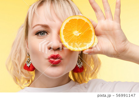 Funny fashionable girl with hairstyle holding 56991147