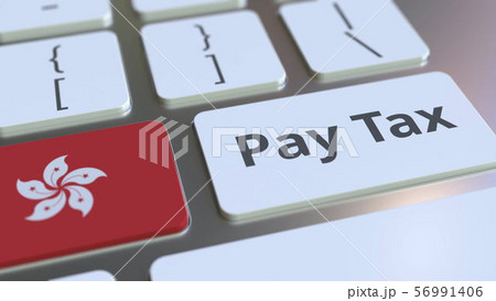 PAY TAX text and flag of Hong Kong on the buttons on the computer keyboard. Taxation related 56991406