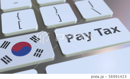 PAY TAX text and flag of South Korea on the buttons on the computer keyboard. Taxation related 56991423