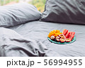 Plate with tropical fruit in grey bed, breakfast 56994955