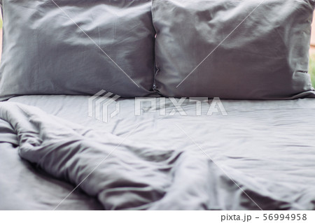 Messy grey hotel bed, honeymoon, background Messy grey hotel bed, honeymoon, background 56994958