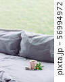 grey Bed next to window, coffee, donut, flower 56994972