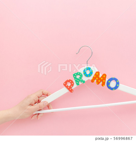 White hangers with promo text on pink background White hangers with promo text on pink background 56996867