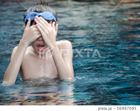 Cute boy in the swimming pool. Happy asian boy in the pool. Cute boy in the swimming pool. Happy asian boy in the pool. 56997095
