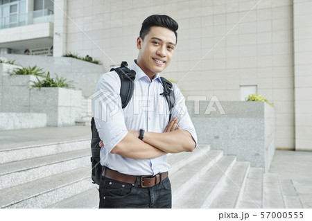 Cheerful programmer standing outdoors 57000555