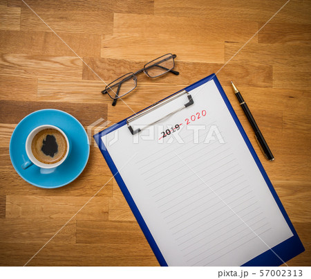 Plans 2020 versus 2019 on wooden board, flat lay 57002313