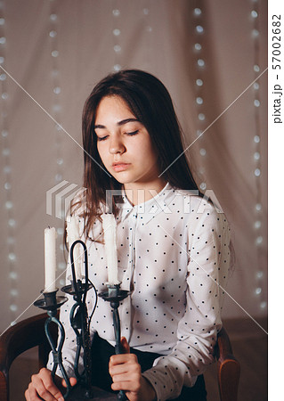 portrait of a girl with a candle. Concept of religious holidays, alternative lighting 57002682