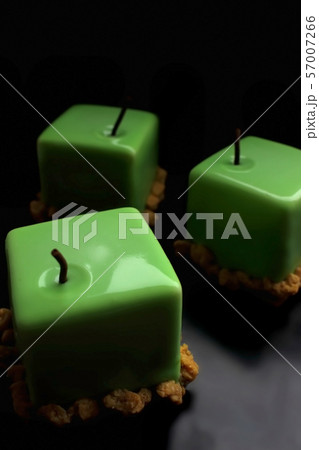Three green apple shiny glazed cube desserts on black background Three green apple shiny glazed cube desserts on black background 57007266