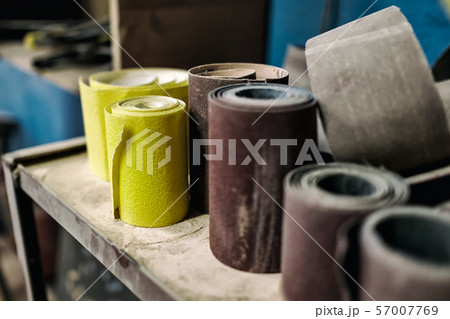 sandpaper of different color and size on workspace. sandpaper of different color and size on workspace. 57007769