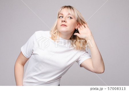 Charming girl listening to gossips. Studio 57008313