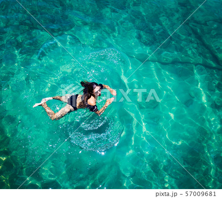 Aerial view of a woman in the sea Aerial view of a woman in the sea 57009681