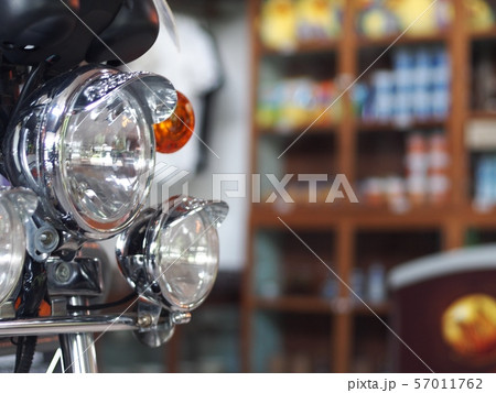 old retro vintage motorcycle front with head and turn signal lamp closeup indoor crop closeup at the headlamp old retro vintage motorcycle front with head and turn signal lamp closeup indoor crop closeup at the headlamp 57011762