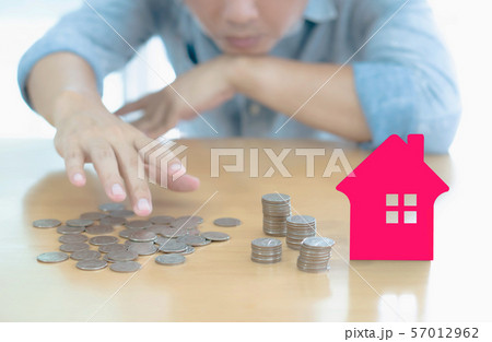 Real estate investment. House and coins on table. 57012962