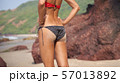 Slender young woman in dressed in black bikini 57013892