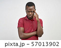 A man from under his forehead looks seriously 57013902