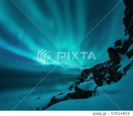 Aurora borealis over rocky beach and ocean. Aurora borealis over rocky beach and ocean. 57014853