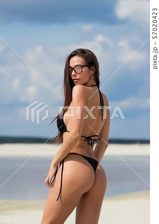 Beautiful woman in swimsuit on beach Beautiful woman in swimsuit on beach 57020423