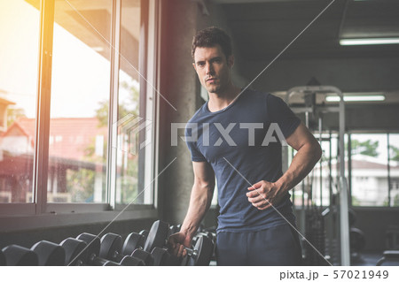 Handsome weightlifter lifting bench press working Handsome weightlifter lifting bench press working 57021949