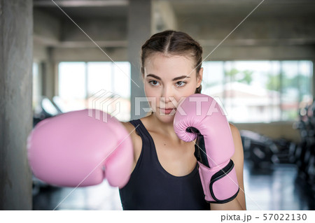 Young beautiful woman with boxing gloves exercise Young beautiful woman with boxing gloves exercise 57022130