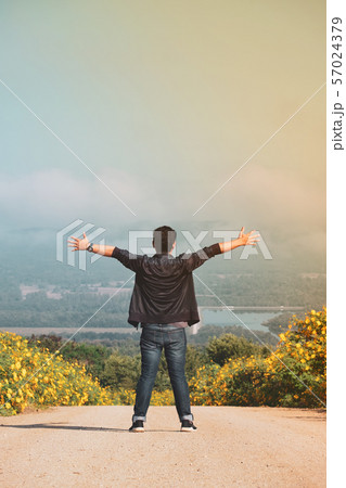 Freedom traveler man standing with raised arms,Top 57024379